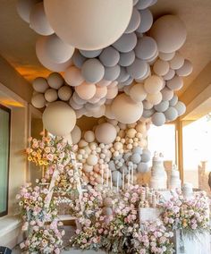 a room filled with lots of balloons and flowers