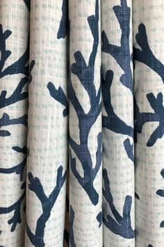 blue and white fabric with trees printed on the front, in shades of indigo blue