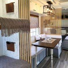 the interior of a tiny home with bunk beds and couches in front of it