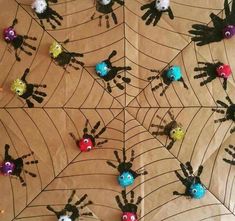 halloween crafts for kids with handprinted spiderweaves and colorful balls on them