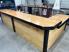 a large wooden table sitting on top of a cement floor