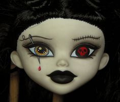 a doll with black hair and red eyeliners on it's face is shown