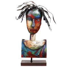 a sculpture of a woman's head on a wooden base with metal strips coming out of it