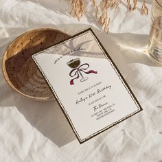 a wine glass sitting on top of a table next to a bowl and paper towel