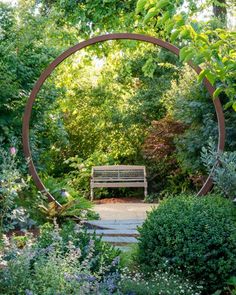 a wooden bench sitting in the middle of a garden