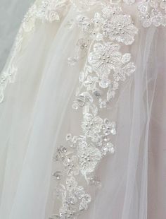 the back of a wedding dress with flowers on it