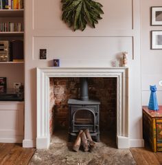 a living room with a fire place and bookshelves