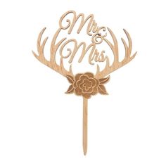 a wooden cake topper with the words mr and mrs on it