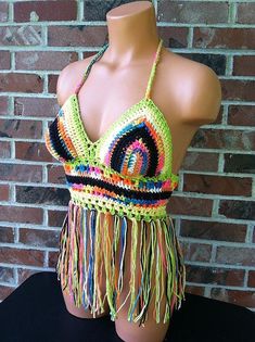 a mannequin wearing a halter top with multicolored crochet fringes