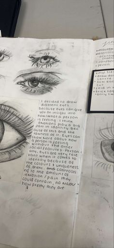 an open book with drawings of eyes and words on the pages that are written in pencil