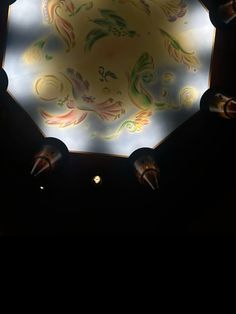 an illuminated ceiling in a dark room