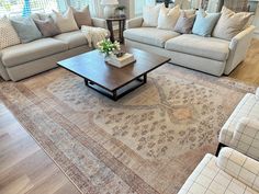 a living room filled with furniture and a large rug