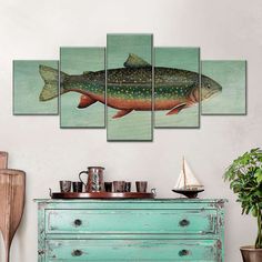 a fish is shown on the wall above a dresser