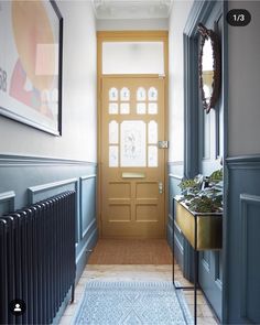 the hallway is painted in blue and has a rug on the floor next to it