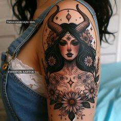 a woman with horns and flowers on her arm