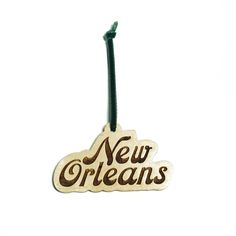 a wooden ornament with the word new orleans hanging from it's side