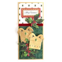 a christmas card with holly and bells on it, hanging from the front of an envelope