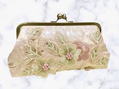 Check out this GORGEOUS clutch from our seller JPE Finery!__ While this purse would be perfect for any special occasion, we think it would especially suit a bride with a blush wedding gown or her maid of honor!__ This handmade clutch was crafted in the state of Washington. __ #handmadeclutch #pinkclutch #floralclutch #handmadefloralclutch #MyCommunityMade #handmadegifts #shopsmallbusiness #etsyalternative #maidofhonorgifts #maidofhonorgift #maidofhonorpurse #weddingpurse #weddingclutch Feminine Gold Rectangular Clutch, Feminine Beige Evening Bag, Beige Feminine Evening Bag, Feminine Beige Evening Bag For Formal Occasions, Feminine Rectangular Evening Bag For Party, Elegant Beige Clutch Evening Bag, Feminine Beige Clutch For Evening, Feminine Rectangular Clutch For Party, Elegant Pink Pouch Evening Bag