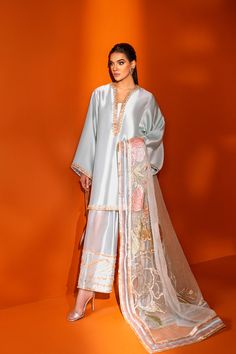 Light blue shalwar-kurta ensemble made in silk, having zardozi and gotta work with the shalwar hem heavily embellished. The dress is paired with an organza dupatta having large embroidered and embellished floral motifs. The dupatta is accentuated with sequin work and borders having fabric detailing. Simple Pakistani Dresses, Designer Party Wear Dresses, Boutique Dress Designs, Stylish Party Dresses, Party Wear Indian Dresses, Stylish Dress Book, Pakistani Dress Design