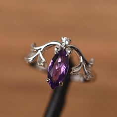 It is a amethyst ring. The main stone is 5 mm* 10 mm marquise cut.weight about 0.87 carats. The basic metal is sterling silver and plated with rhodium. To change the metal to a solid gold (white/rose) or platinum is also available, please ask for a quotation if you want. You can also go to my shop Home for more elegant rings: https://www.etsy.com/shop/godjewelry?ref=hdr_shop_menu Alexandrite is June birthstone More alexandrite rings: https://www.etsy.com/shop/godjewelry?ref=seller-platform-mcnav Purple Marquise Cut Amethyst Promise Ring, Purple Amethyst Promise Ring In Marquise Shape, Purple Marquise Amethyst Promise Ring, Marquise Amethyst Ring For Anniversary, Marquise Amethyst Anniversary Ring, Marquise Amethyst Ring With Prong Setting, Purple Marquise Amethyst Ring With Prong Setting, Alexandrite Rings, February Birthstone Ring