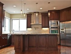 a kitchen with wooden cabinets and stainless steel appliances