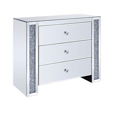 a white dresser with silver glitter on the drawers