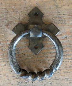 an old metal handle on a wooden door