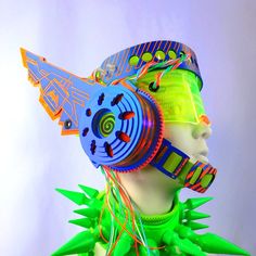 a mannequin with headphones and neon colors on it's face is shown