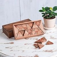 a wooden box sitting on top of a white table next to a potted plant