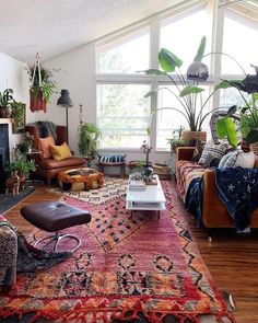 a living room filled with furniture and lots of plants