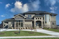 a large house with lots of windows and landscaping