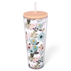 the tumbler is decorated with colorful flowers and leaves, along with a straw lid