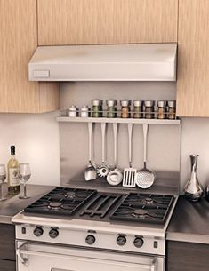 a stove top oven sitting inside of a kitchen next to a wall mounted spice rack