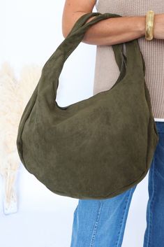 -Material: Faux suede -Closure: Magnetic snap closure and side snap closures -Pockets: Inner zip pocket and two slip pockets Dimensions: -Length: 17 inches -Height: 21 inches -Depth: 5.5 inches Casual Suede Hobo Bag For Travel, Casual Suede Hobo Bag For Daily Use, Casual Fall Hobo Bag With Zipper Pocket, Casual Suede Bags For Fall, Casual Olive Shoulder Bag With Pockets, Casual Leather Hobo Bag With Pockets, Graphic Print Top, Side Snap, Loungewear Sets