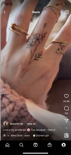 a person's hand with two different tattoos on it, and one is holding the other