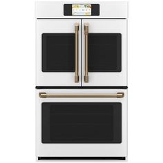 a white double oven with gold trimmings and two built - in microwaves