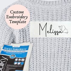 a close up of a person's sweater with the name meligoa on it