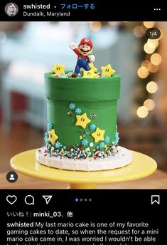 a green cake with mario on top and stars around it