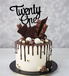 there is a cake that has chocolate on it and the words twenty one are spelled in black