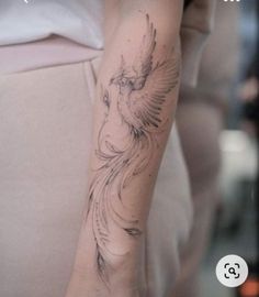 a woman's arm with a bird tattoo on the left side of her arm