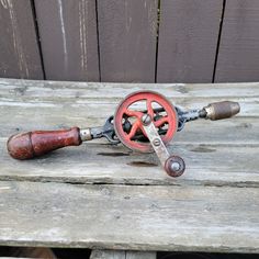 an old fishing rod and reel on a wooden bench