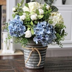 a vase filled with blue and white flowers