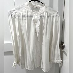 Nwt Loft Outlet Blouse. Size Xs Petite. White With Full Button Down Front, Lace Detail Along Front Buttons And Neckline. Ruffle Sleeves With Bows. Flawless Condition! Approximate Measurements Lying Flat: Pit To Pit: 19.5” Length Shoulder To Bottom Hem: 23” Length Shoulder To End Of Sleeve: 17.5” Make An Offer! Feminine Shirt With Button Closure For Day Out, Feminine Button-up Top With Button Closure, Feminine Button-up Tops With Buttons, Feminine Button-up Blouse With Buttons, Feminine White Button-up Shirt, Feminine Button-up Blouse For Daywear, Feminine Shirt With Buttons For Daywear, Feminine White Tops With Button Closure, Feminine Shirt For Daywear With Buttons