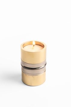 a candle that is sitting in front of a white background with three rings around it