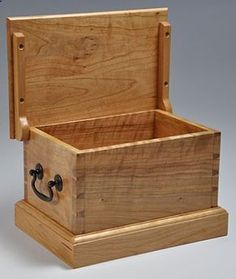 a wooden box with an open lid and handles