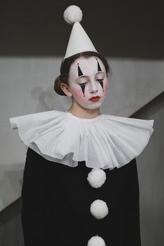 a woman with clown makeup on her face