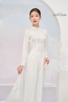 "\"Tinh\": white, pure, elegant \"Kỳ\": sophisticated \"Tinh Kỳ\" collection centers around white áo dài, featuring designs ranging from simple to sophisticated. Whether you need a white áo dài for a casual or special occasion, there is one for you. Each design is made of high-quality materials, embodying so much detail to create a style that is both subtle and distinctive. As always, our focus lies on elegance, quality, and size inclusivity.  ❣️ This set includes one Ao Dai Top and Pants Style: Traditional  Material: Silk. Some Stretch  Model wears size S ❣️ Please note: - Sizing may run smaller than American standard sizes, please refer to the sizing charts. - Please contact us if you have any questions ❣️We are proud to provide you with the highest quality fabric, handpicked modest colo Traditional White Ao Dai For Formal Occasions, Elegant Stretch Wedding Sets, Elegant Stretch Sets For Wedding, Solid Color Sets For Spring Wedding, Solid Color Long Sleeve Wedding Set, Solid Long Sleeve Wedding Set, White Fitted Ao Dai For Wedding, Elegant White Ao Dai For Formal Occasions, Traditional Fitted White Ao Dai