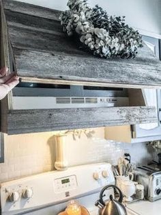 a stove top oven sitting inside of a kitchen