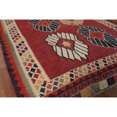 a red rug with many different designs on it