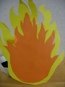 an orange and yellow fireball sitting on top of a wooden table next to a white wall